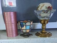 All items side by side: pillar candle, stained glass votive, assembled brass & glass holder with sphere candle