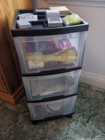 Overall view of 3-drawer storage unit with visible ribbon spools and gift boxes