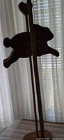 Full view of pine decor showing rabbit silhouette, heart finial, measuring tape for scale