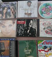 All nine CDs laid out showing front covers and one loose disc