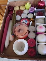 Overview of box showing assorted tapers, tealights, votives, pillar and accessories