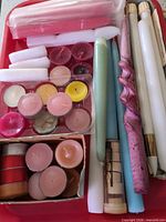 Top view of entire assortment showing tapers, tealights, decorative candle and packaging