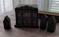 Front view of Dominion Bank coin bank with three canal house miniatures