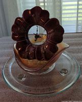 Lot overview showing burgundy flower tealight holder with hummingbird, carnival glass candy dish, glass trivet
