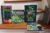 Front covers of five gardening books on stair