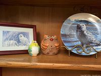 Front view of framed print, two owl banks, plate on stand
