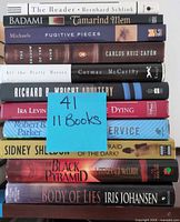 Stack of 11 book spines showing titles and authors