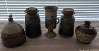 Group shot of five pottery pieces showing size and glaze colors