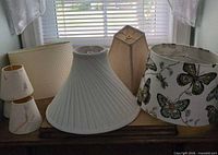 All seven lampshades on dresser