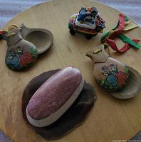 Top view showing both castanets, agate slice, stone bowl with lid, painted bus