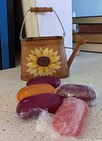 Front view of wood watering can basket with sunflower and five soap bars