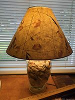 Full view of lamp showing shade and glass base filled with shells