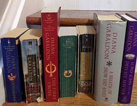 All seven books standing, spines visible