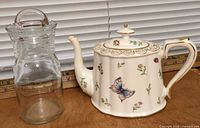 Teapot and glass jar side by side showing relative size and designs