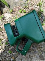 Green handheld spreader side view