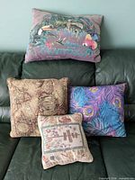 Group shot of all four pillows showing designs and relative sizes