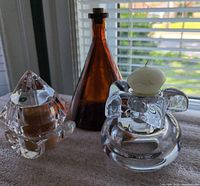 Amber glass bottle, pyramid and spherical crystal holders with candles