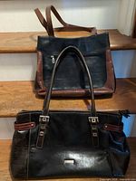 Two leather handbags, Joanel in front, Valentina behind