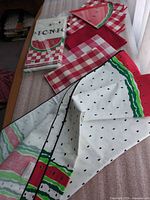 Overall lot with fabric tablecloth, sealed paper tablecover package, stacks of cloth napkins