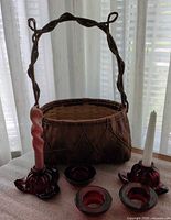Basket, two floral taper holders, three round tealight holders, two candles