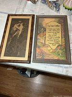 Pair of framed prints on table showing overall condition