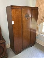 Front view of single-door Art Deco wardrobe cabinet