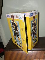 Front and side view of boxed Bobby Orr figure