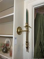 Full view of first brass wall sconce with candle