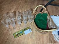 All ten crystal flutes, package of glass markers and wicker basket on floor