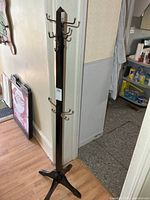 full view of coat rack showing height, base, hooks