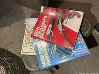 All three firearm-related books stacked