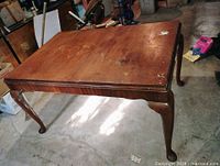 Overall view of wooden dining table top and legs