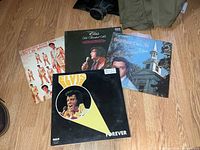 Four Elvis Presley LPs spread out on floor
