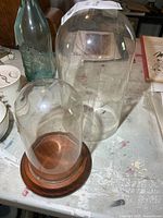 Both glass domes side by side showing size difference