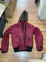 Full view of Noize burgundy winter coat laid flat showing overall design
