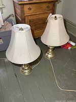 Both brass-tone table lamps with shades