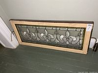 Full view of leaded glass panel resting against wall