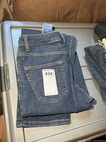 Folded jeans showing rear pocket and tag