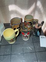 Group shot of mug, glass, pitcher, stein and teapot