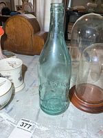 Full view of aqua glass bottle on tabletop