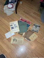 Entire lot spread on floor showing seven paper items