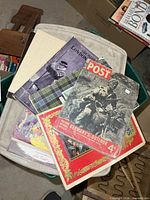 Stack showing Picture Post, Illustrated London News issues, Disney publication and sheet music