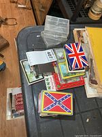 Stack of multiple playing card decks on table, including flag and scenic designs