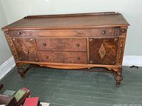 Front view showing drawers, cabinet doors, legs