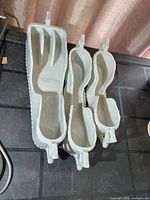 Top view of three porcelain spooners showing interior compartments and handles