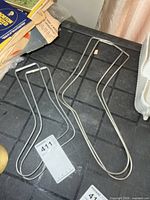 Adult and child metal sock stretcher pairs on tabletop