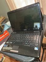 Laptop open showing screen, keyboard, overall condition