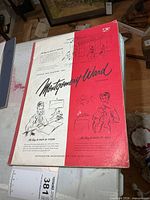 Front cover showing Montgomery Ward logo, sketches, red/white design