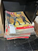 Stack of Life magazines on shelf, top issue March 24 1967
