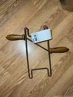 Front view of steel rod rope winder with wood handles